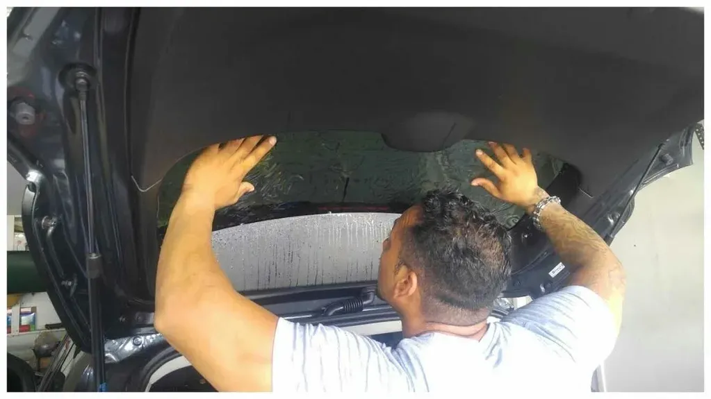 Master tinter Elie installing a one-piece rear window tint